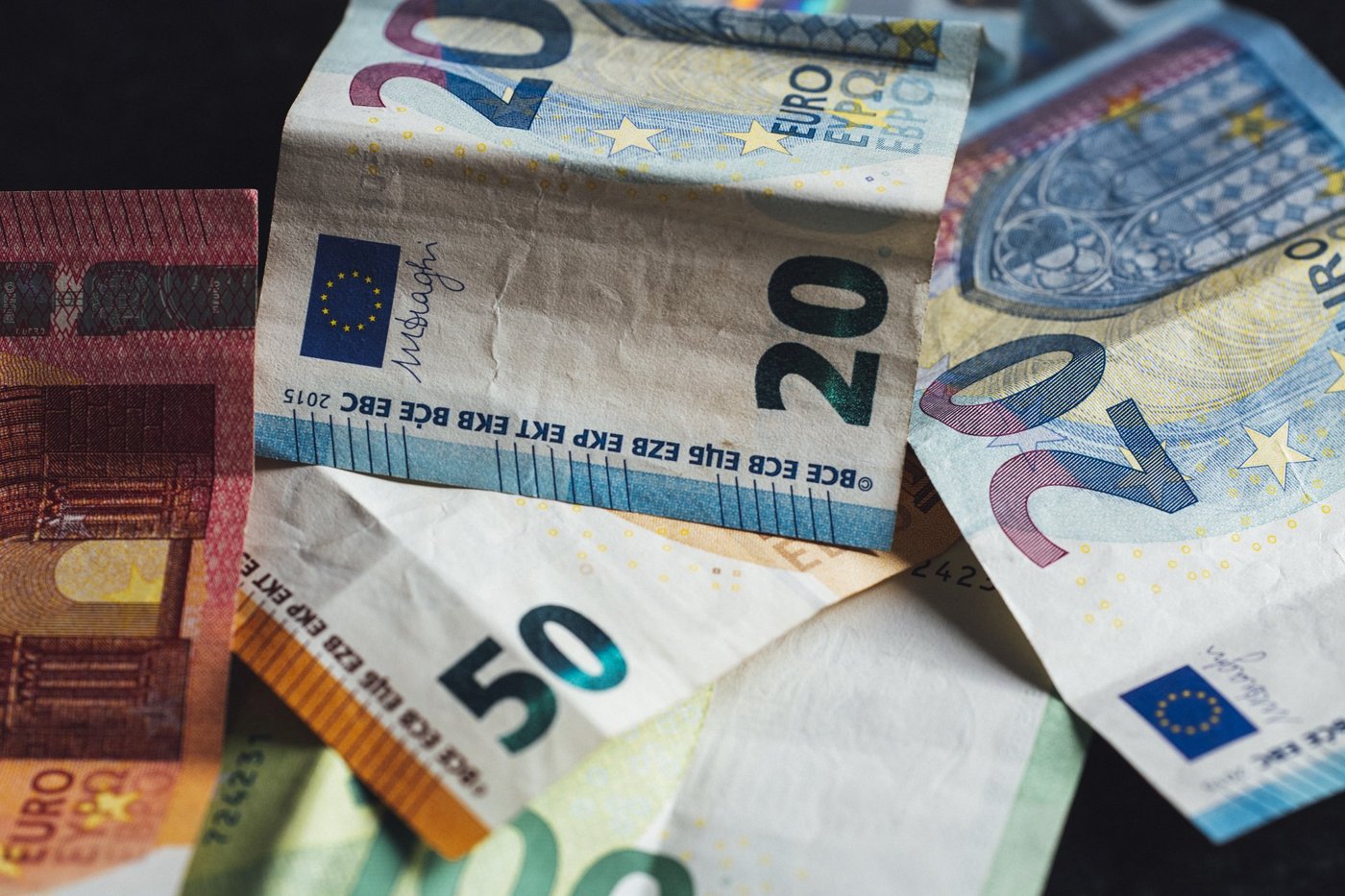 Verkreukelde eurobiljetten van twintig en vijftig euro naast elkaar.